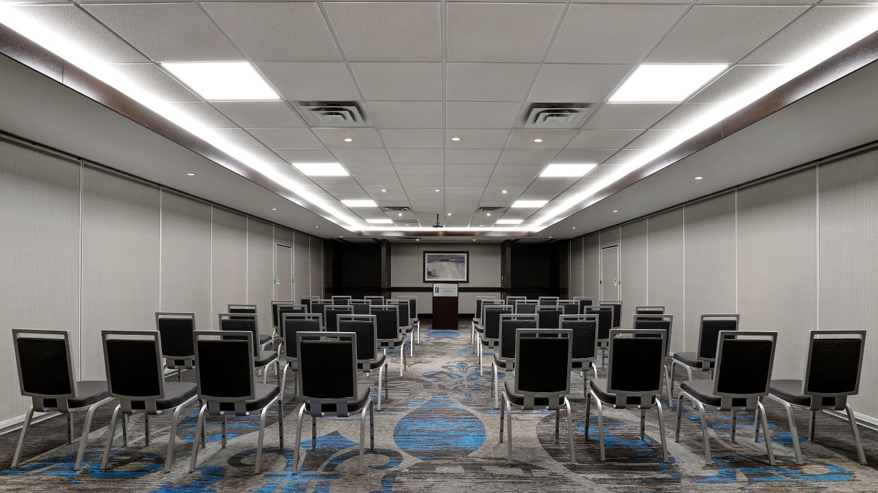 Large, bright presentation space with rows of seating facing a podium.